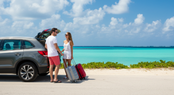 Couple enjoying a weekend getaway with a rental car in the Bahamas — Dinero Rentals.